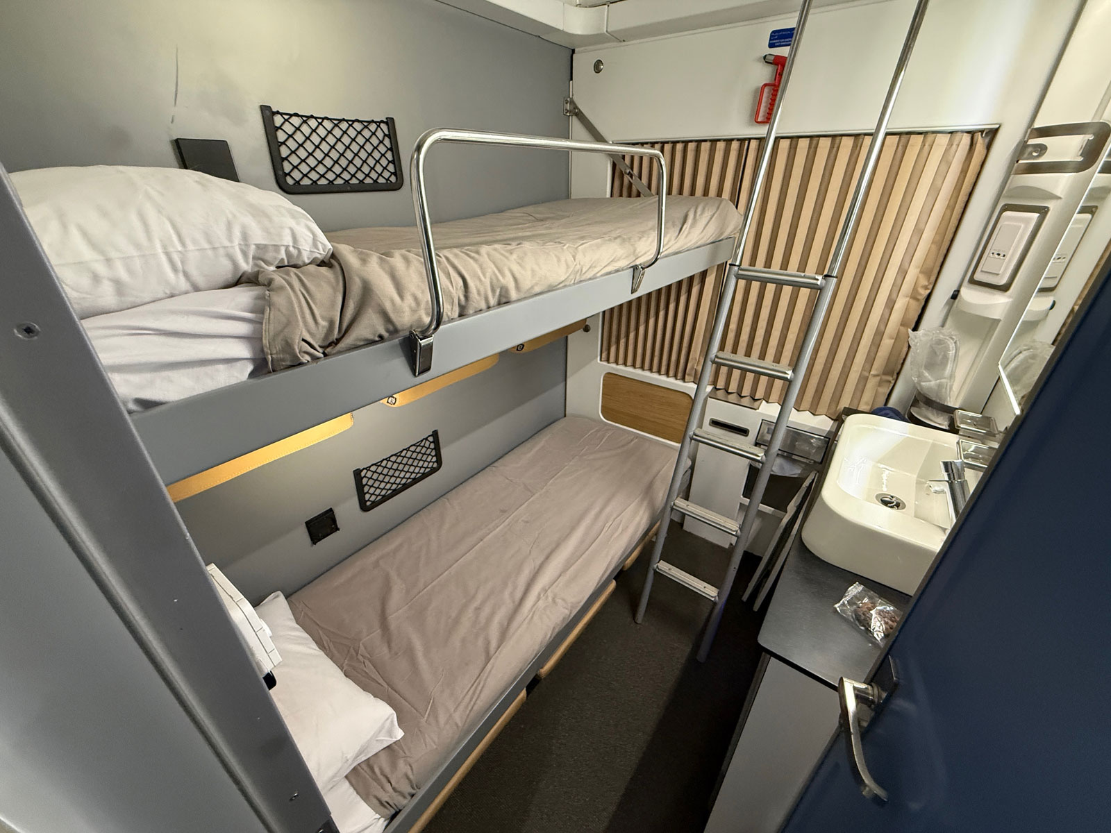 Twin bunk beds and wash basin in an Abela Elite Sleeper cabin